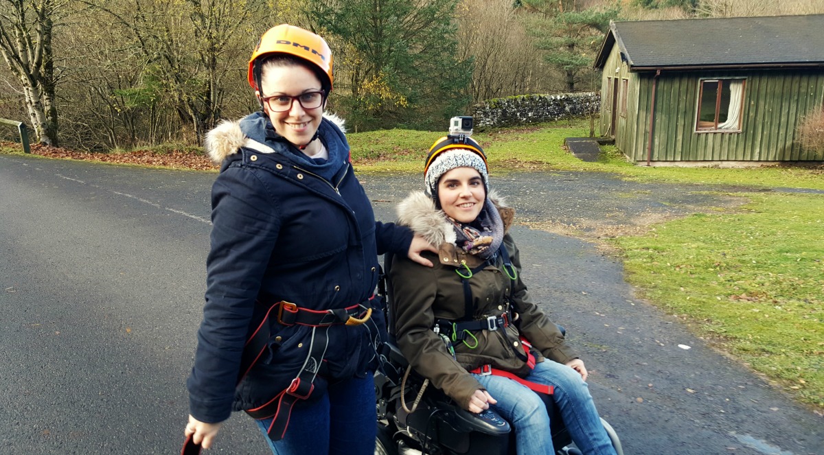 Emma and her sister wearing safety helmets and harnesses.