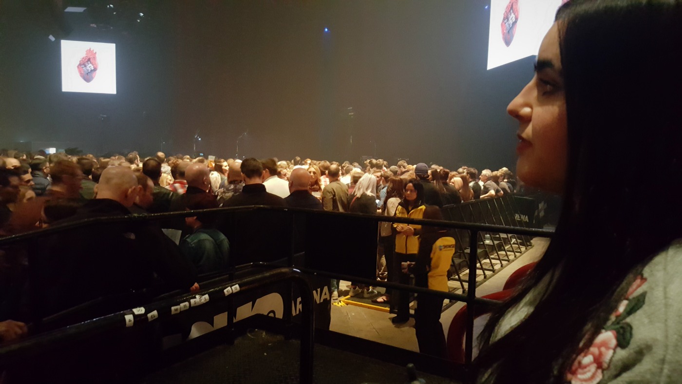 Emma sitting in the accessible seating area with the view of the stage in the background.