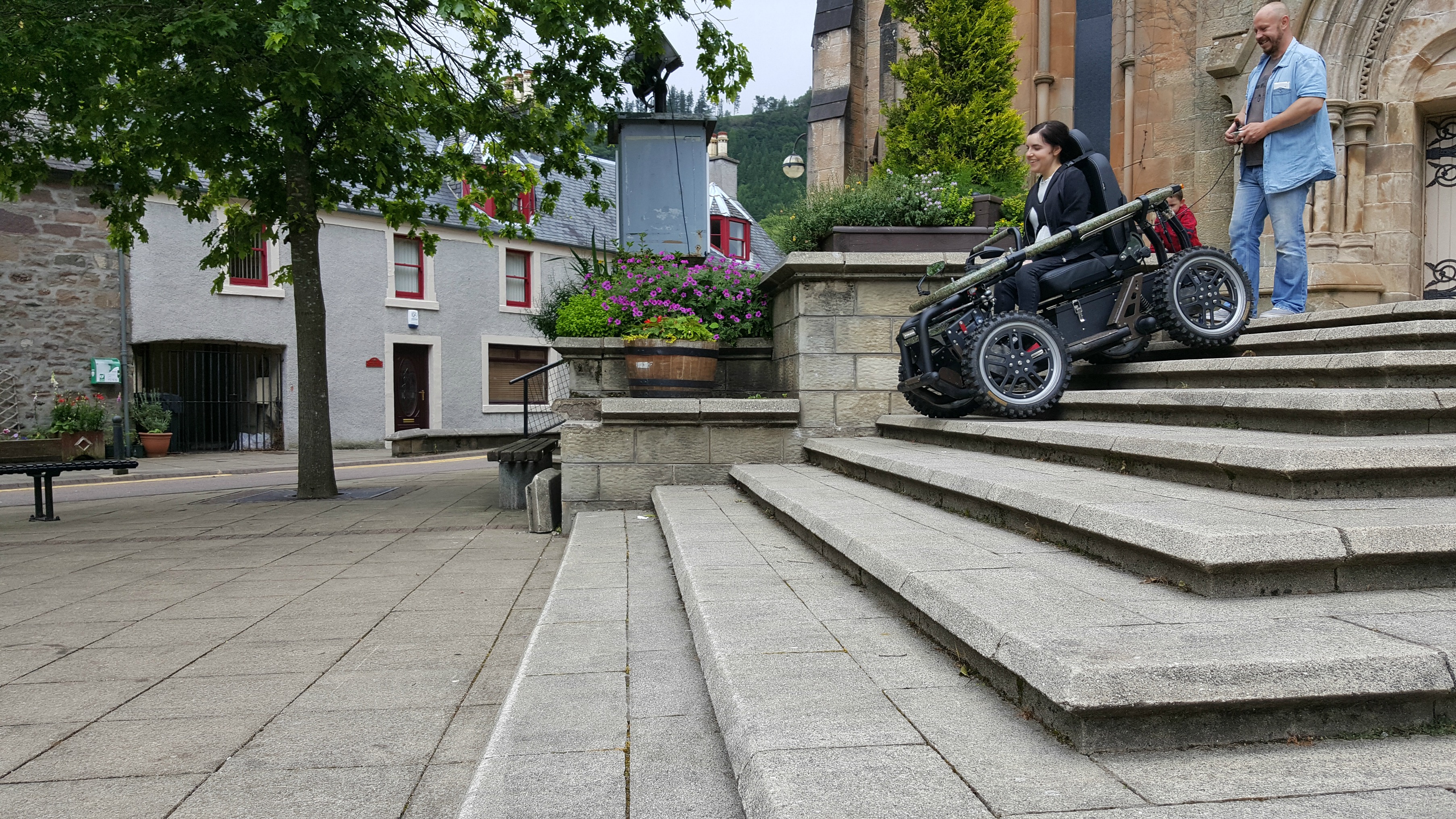simply emma driving all-terrain-wheelchair down steps callander