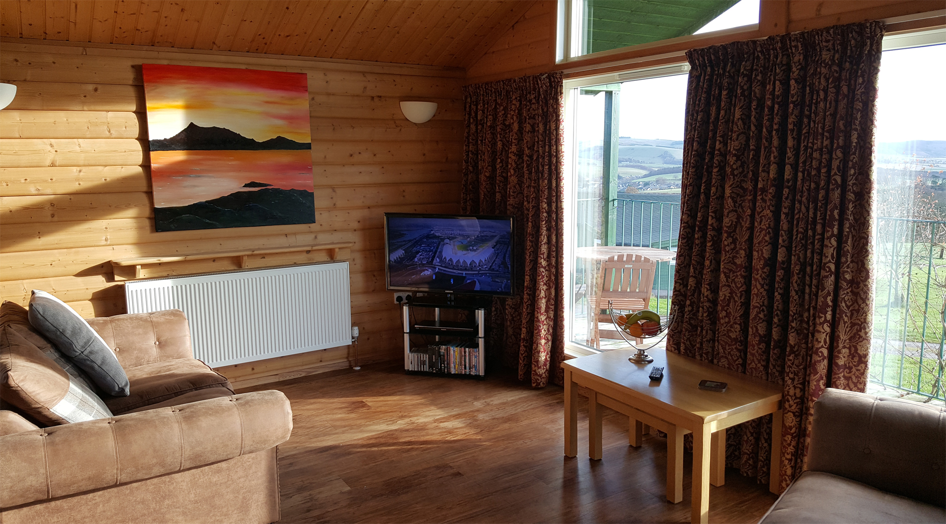 The living area with view out the large windows in The Ramsay at Airhouses Luxury Self Catering Lodges in Scottish Borders 