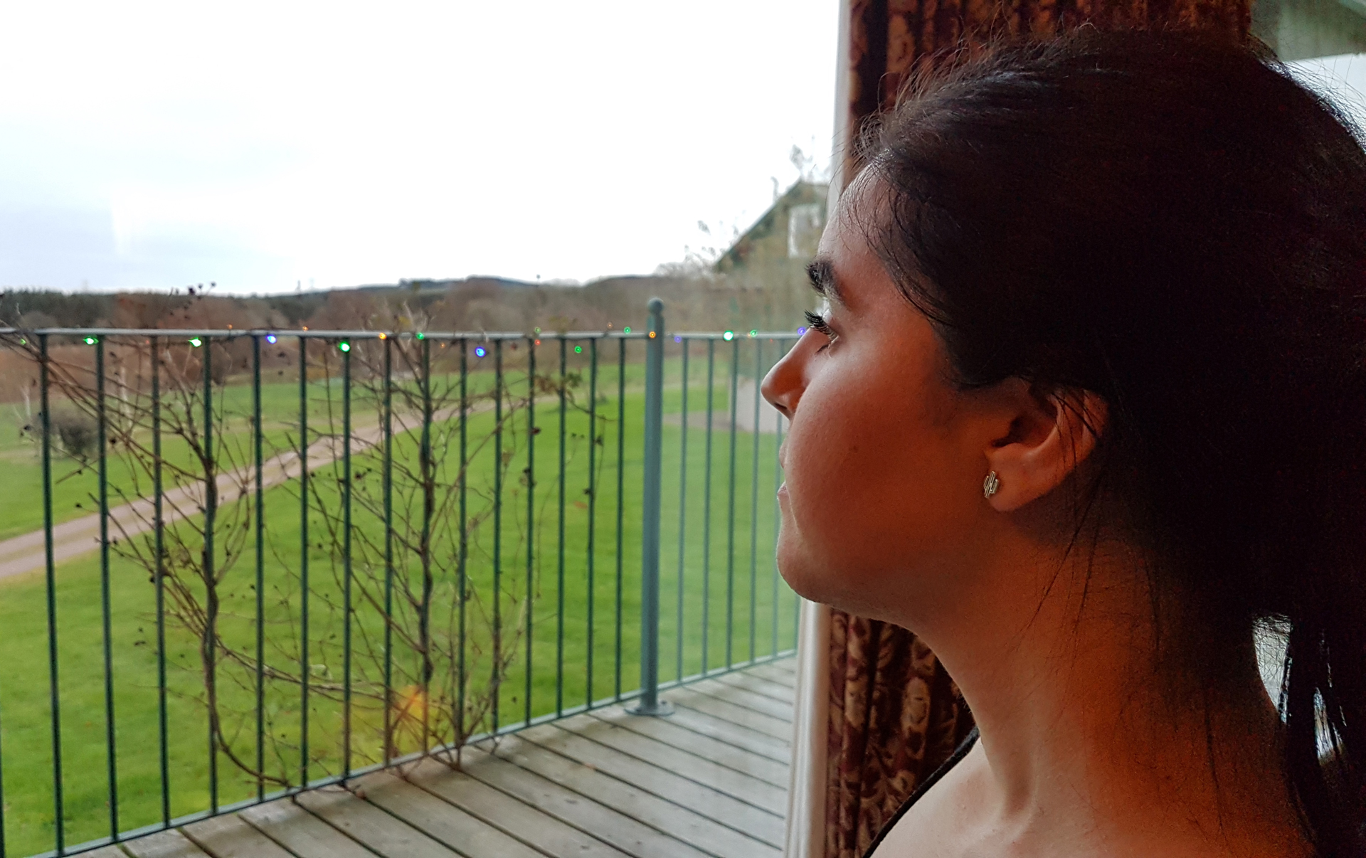 Emma looking out the large livingroom windows at the beautiful view at Airhouses Luxury Self Catering Lodges in Scottish Borders 