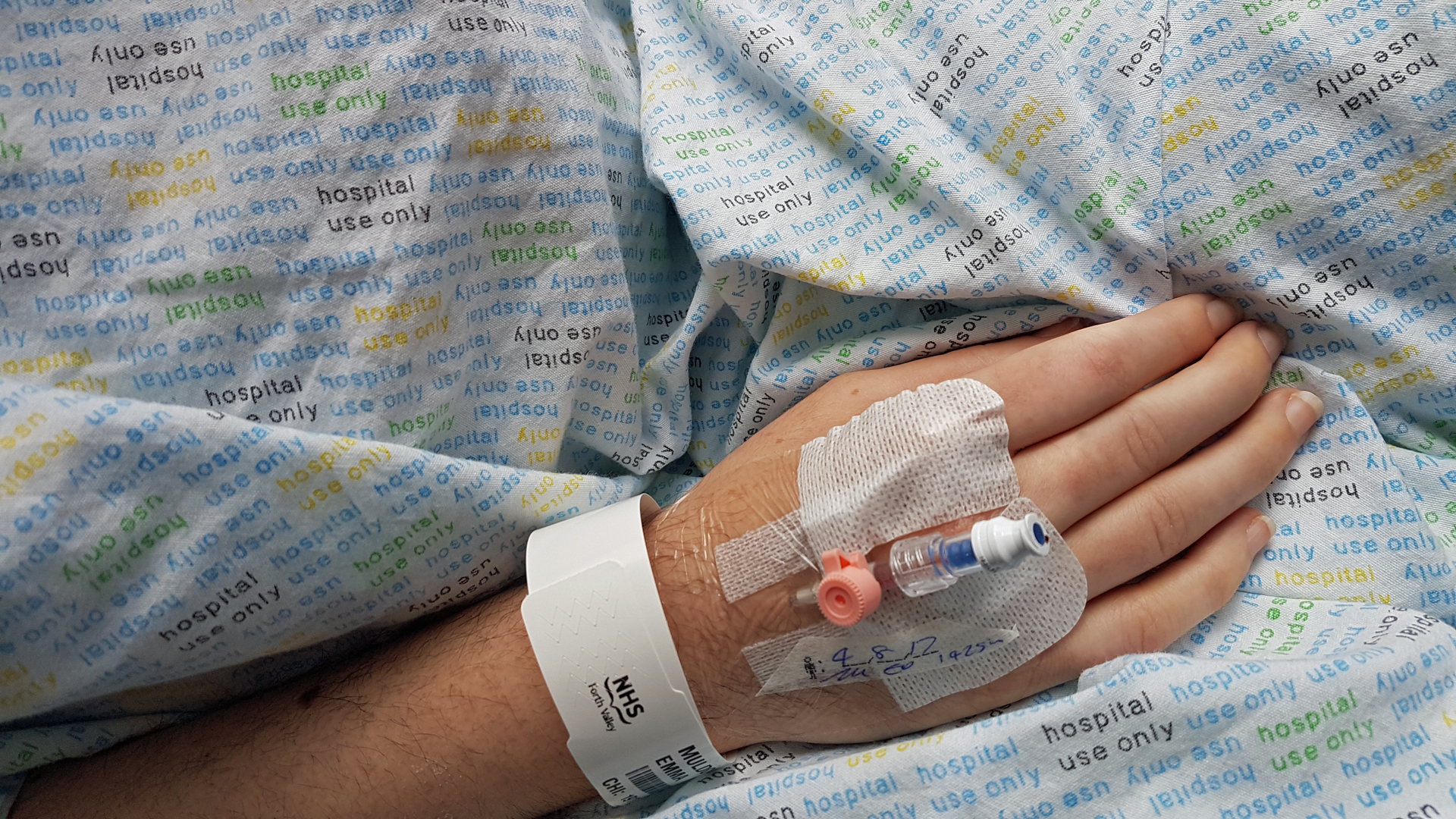 Emma of Simply Emma laying in a hospital bed with a cannula pumping IV into her body. Disabled Hospital Inpatient.