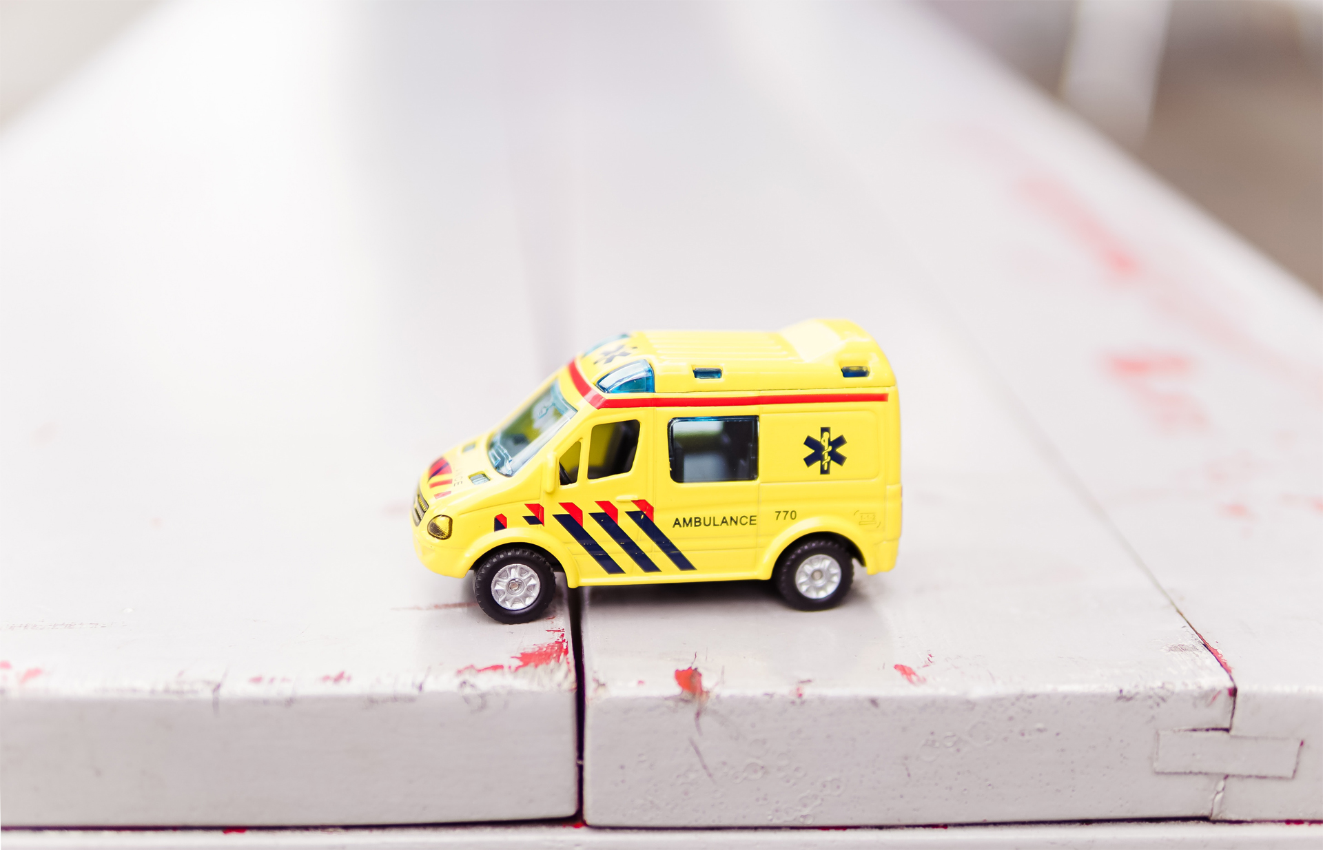 Picture of a yellow toy ambulance,