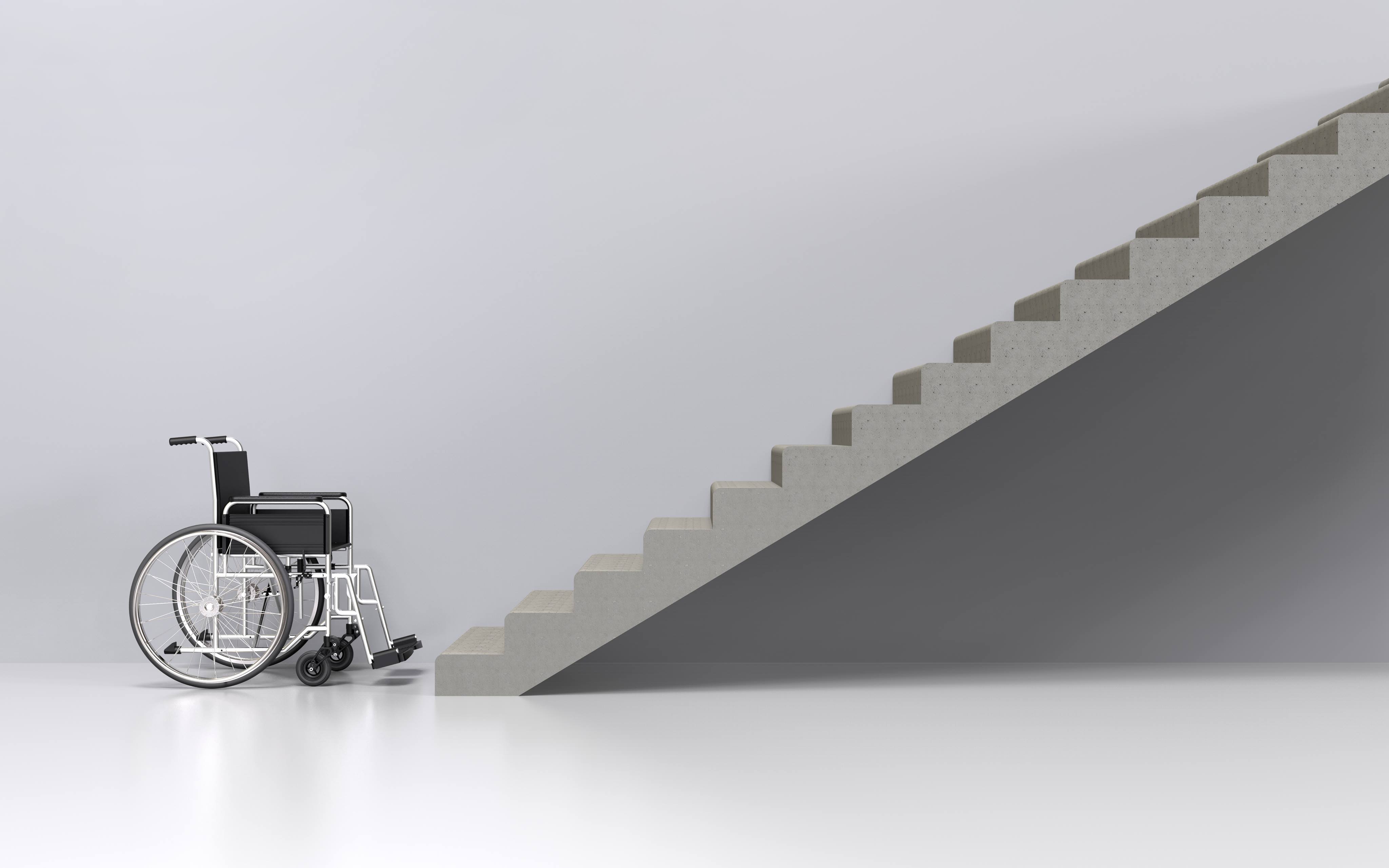 Wheelchair sitting at the bottom of stairs. How To Make Your Home Wheelchair Accessible