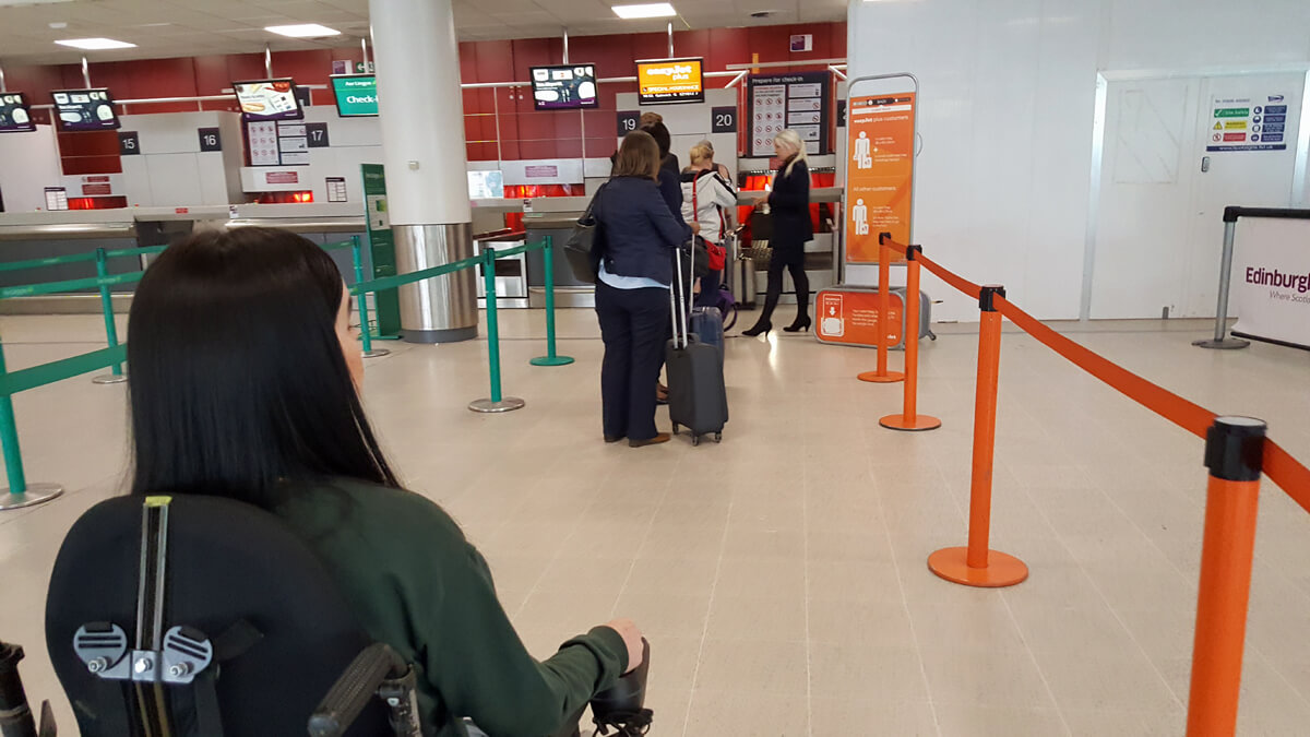 Emma waiting in the easyJet special assistance check-in desk.