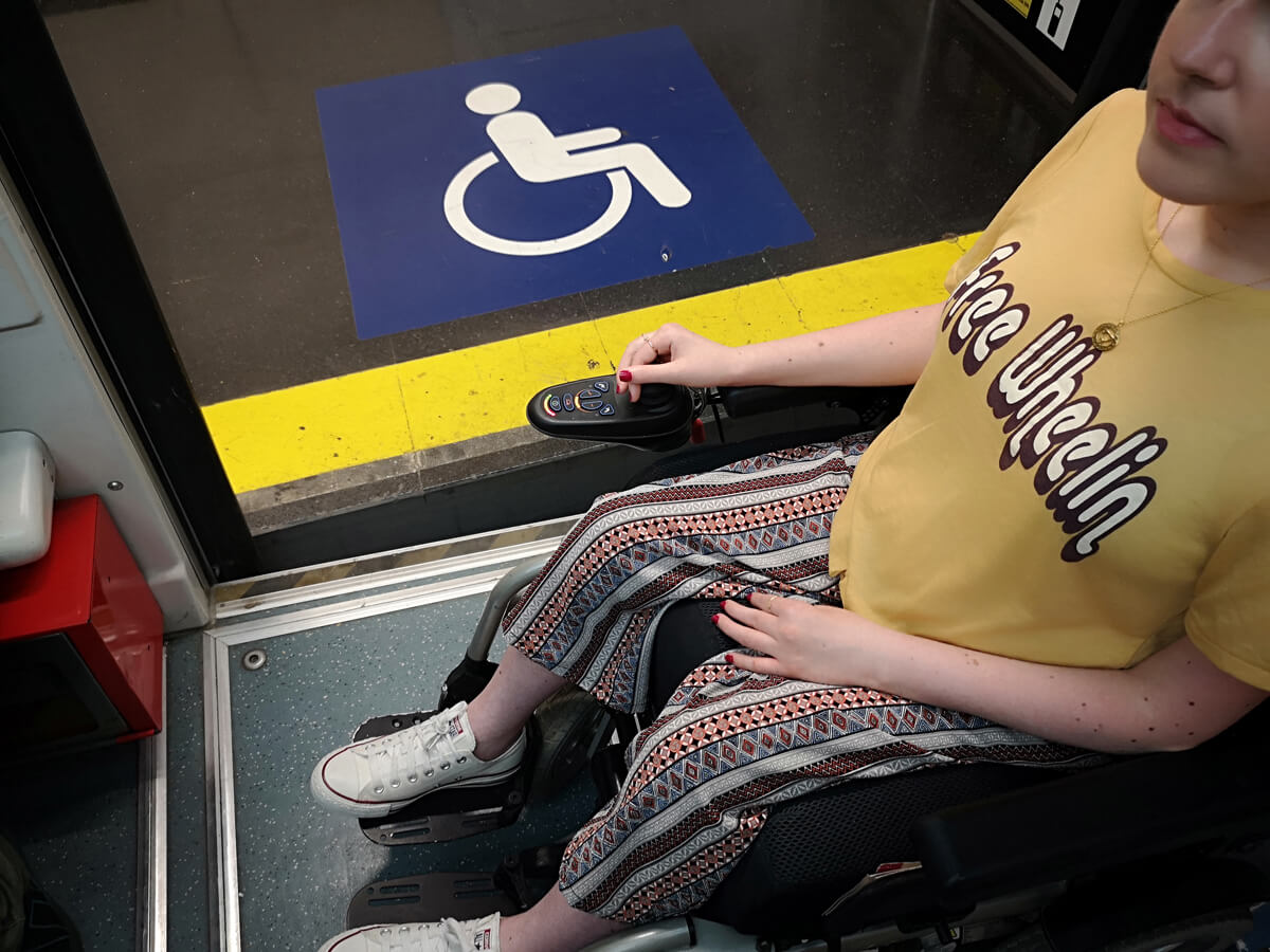 An shot of the uneven platform floor and entrance of the funicular to show access for wheelchairs. Emma is sitting in her wheelchair on the funicular.