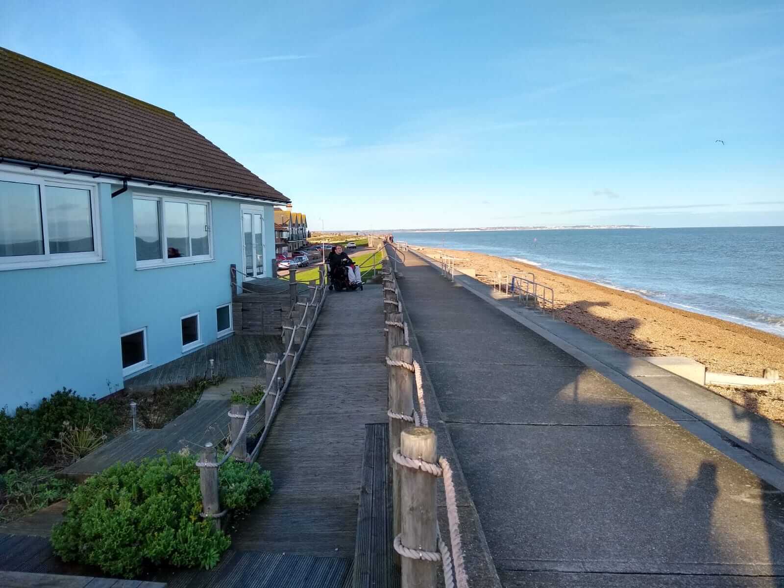 The exterior of the cottage and beach promenade.