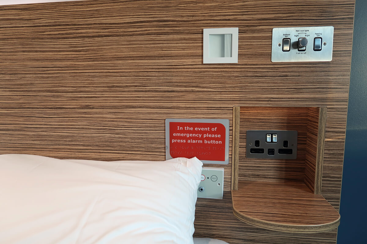 A close up of the bedside shelf in the wheelchair accessible SuperRoom at Travelodge.