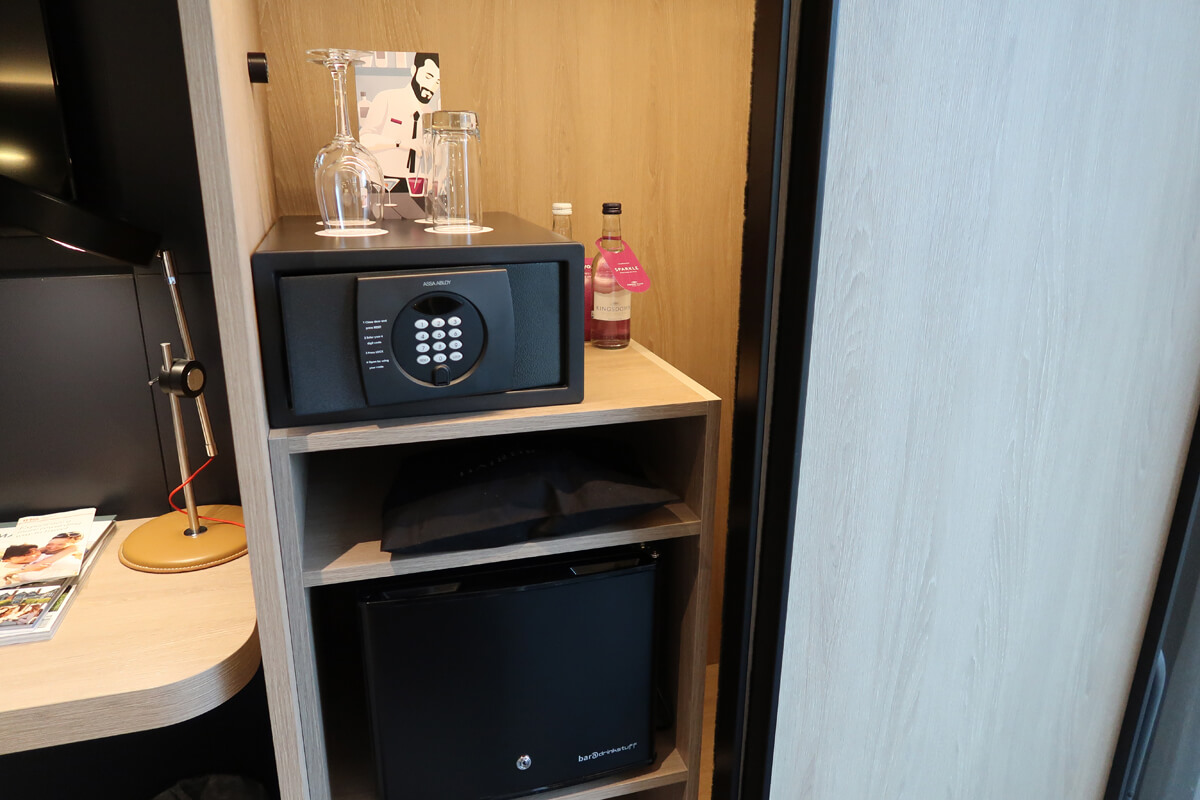 Closet with sliding door. A safe, mini fridge and hairdryer were inside.