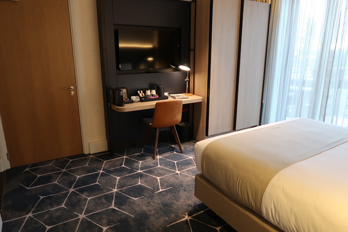 Work desk in our accessible hotel room. A large flatscreen TV is wall mounted above the desk.