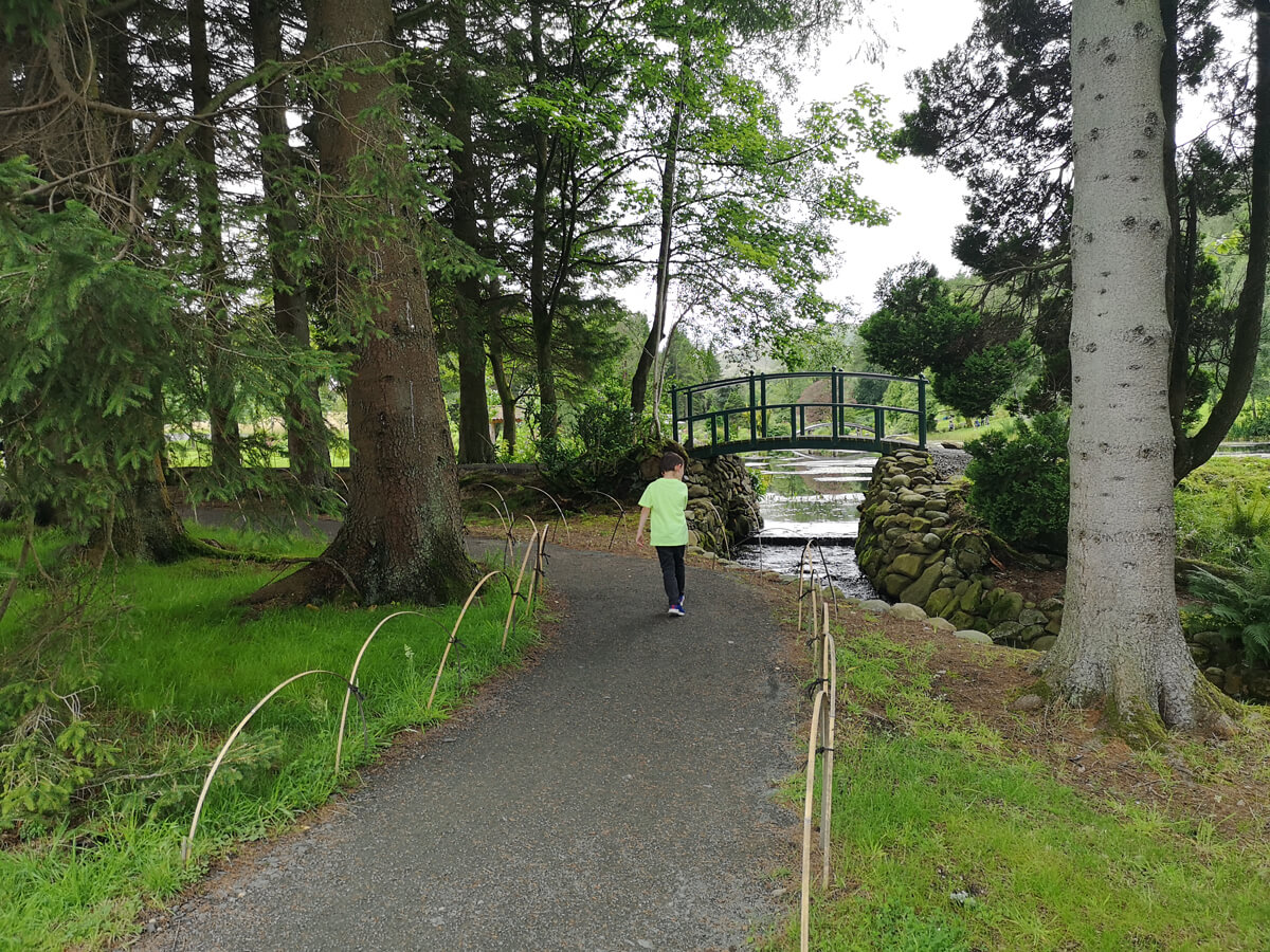 A little boy walking into the entrance of Japanese Garden at Cowden.