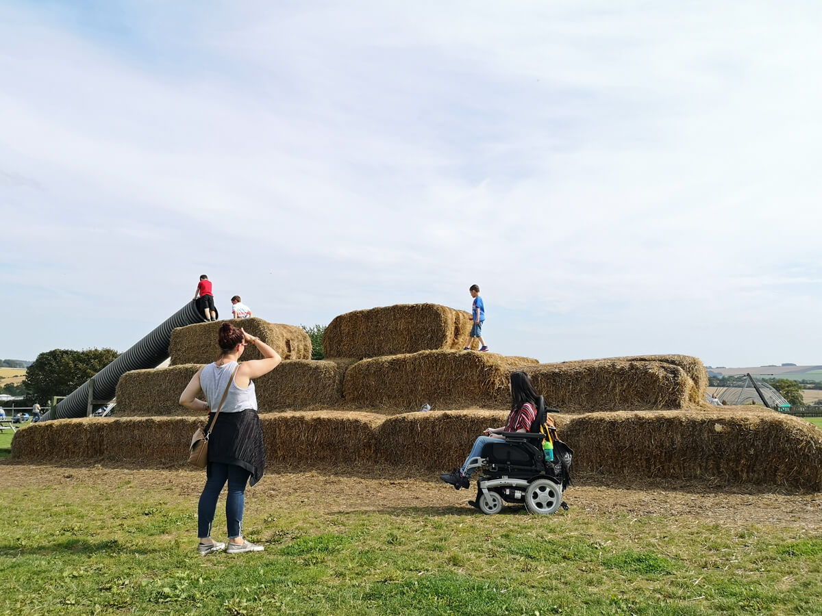 Emma and her sister beside the giant straw bale climbing fortress.
