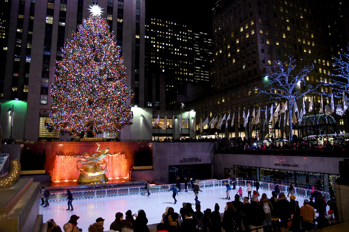 A view overlooking the ice rink and Rockefeller Centre Christmas Tree at night.