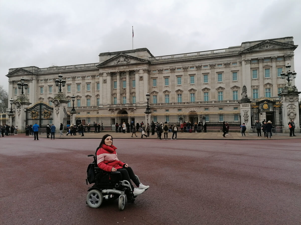 Emma posing outside Buckingham Palace