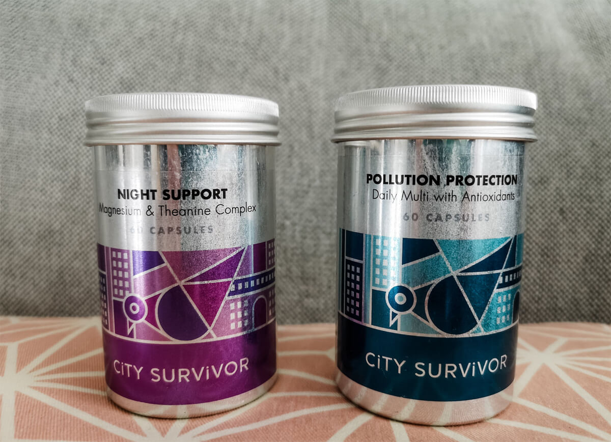 Two metal tins containing supplements. Pollution Protection has a blue design on the tin and Night Support has a purple design. 