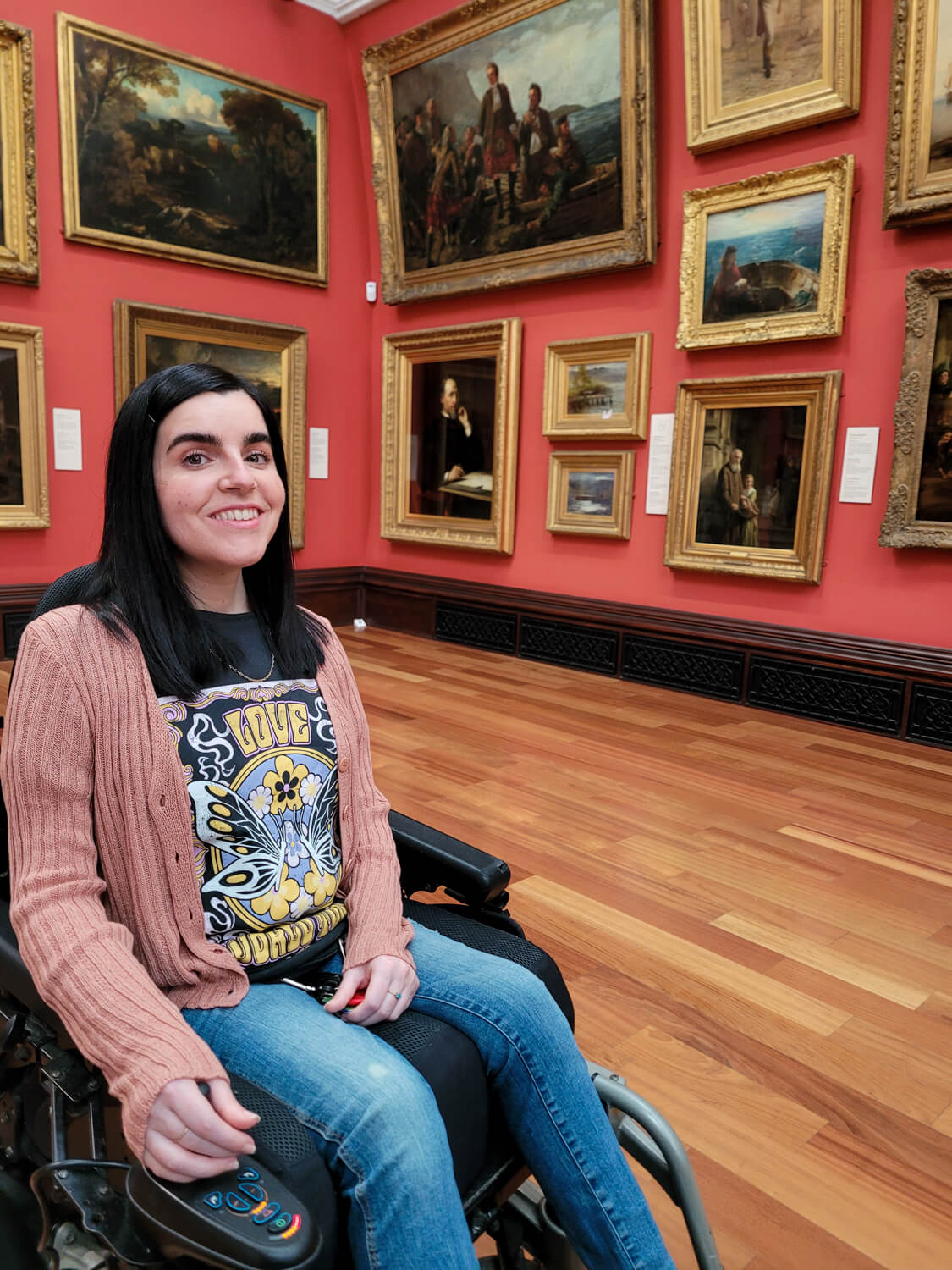 Emma sat in her wheelchair inside The Victoria Gallery at The McManus