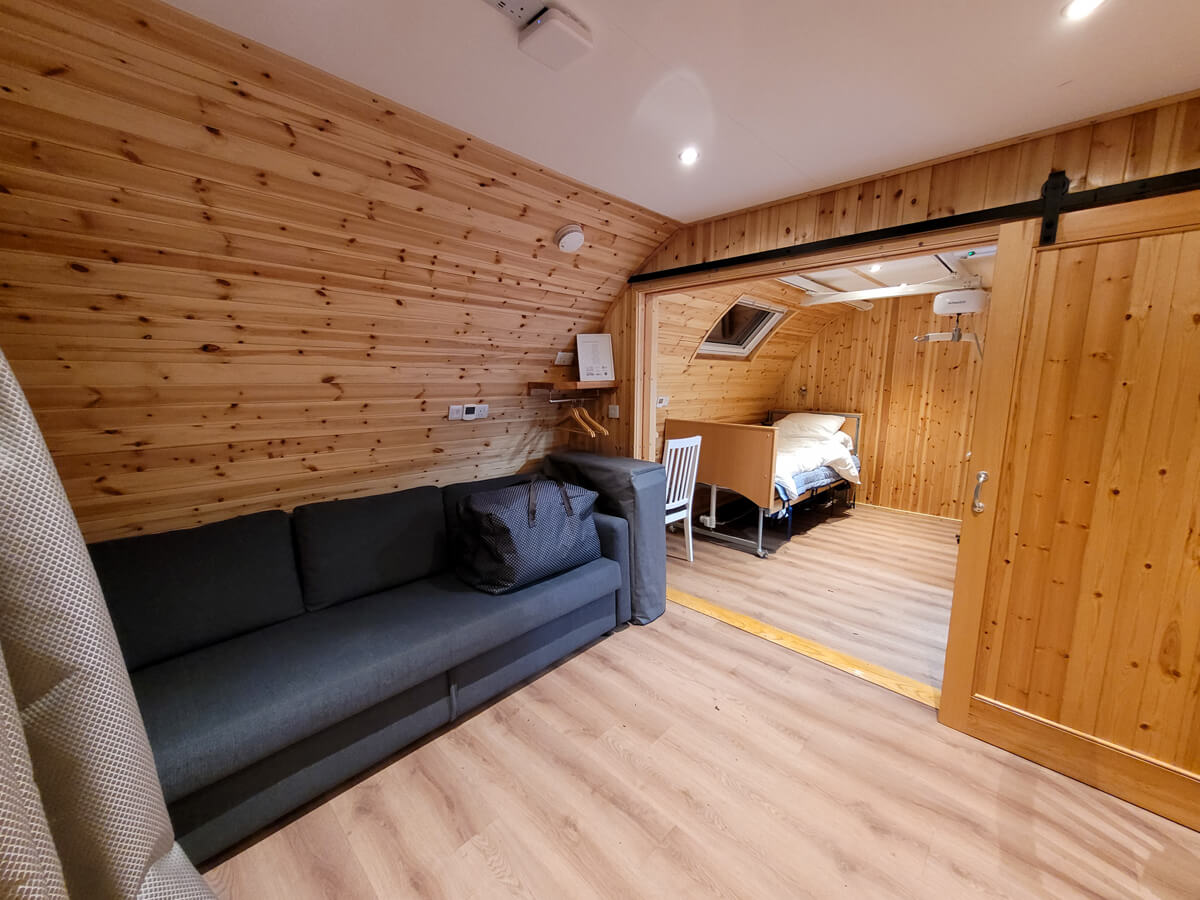 Lounge area with a view into the bedroom area at Callander CYP Crags Accessible Glamping Pod