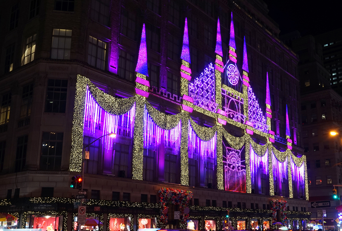 Saks Fifth Avenue holiday display light projection onto the building’s facade.