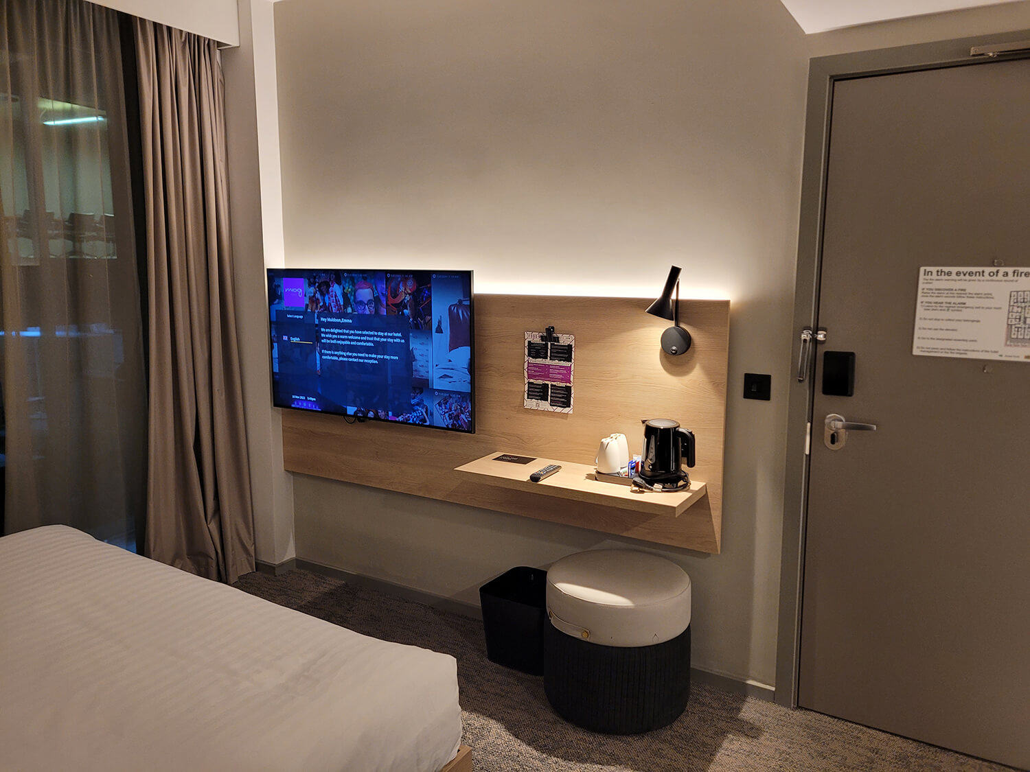 A wall mounted TV and desk in a room at the Moxy Manchester City hotel.