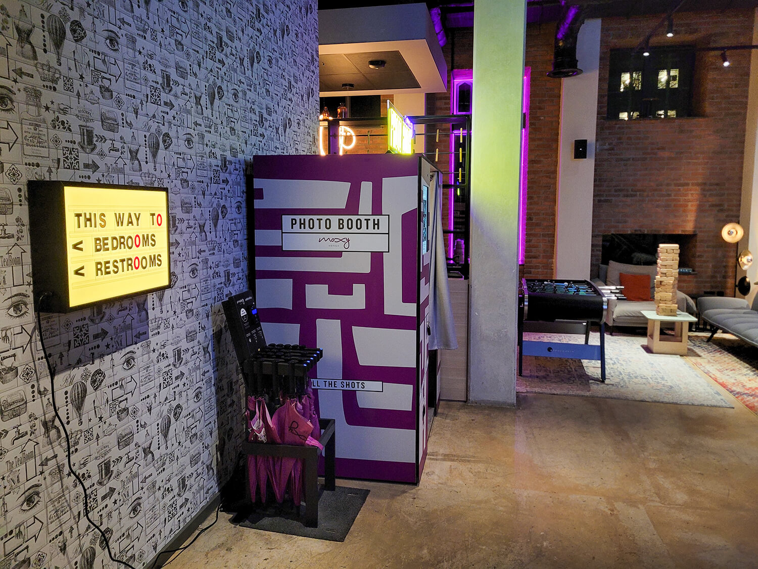 The lobby in at the Moxy Manchester City hotel. There is a photo booth, social space with giant jenga and table football.