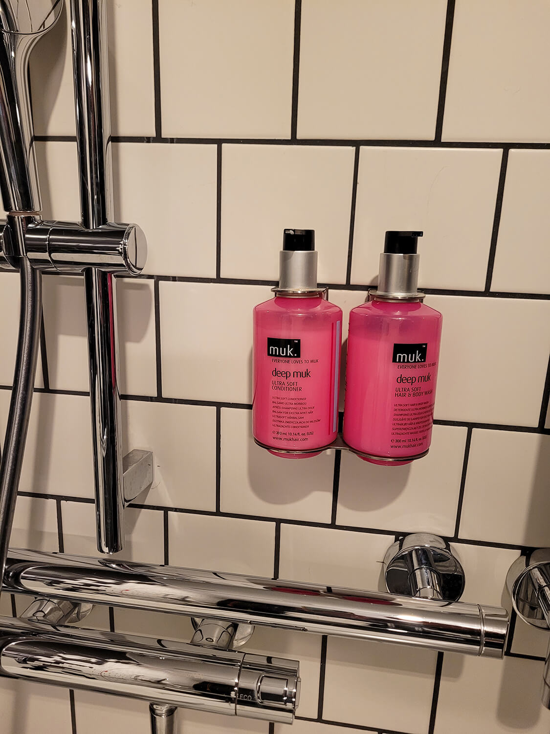 Muk shower toiletries in the shower at the Moxy Manchester City hotel.