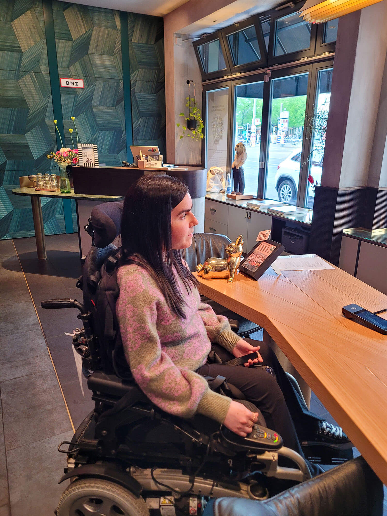 Emma sat in her wheelchair at the reception desk at the Circus Hotel while checking in.