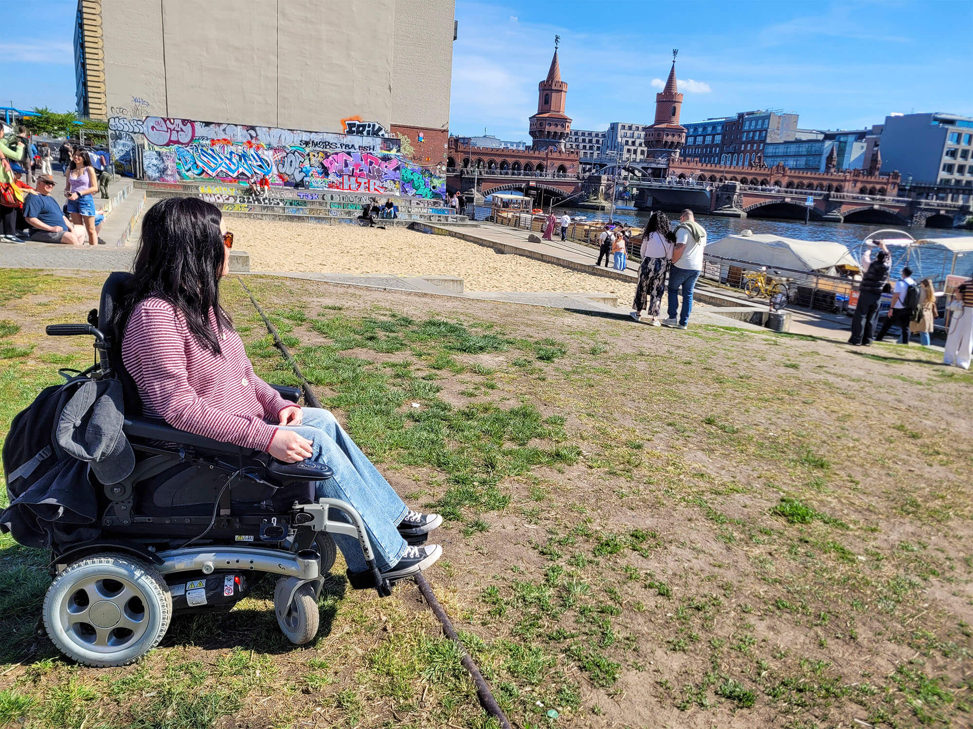 Emma, a powerchair user is looking over at the Oberbaum Bridge (Oberbaumbrücke)