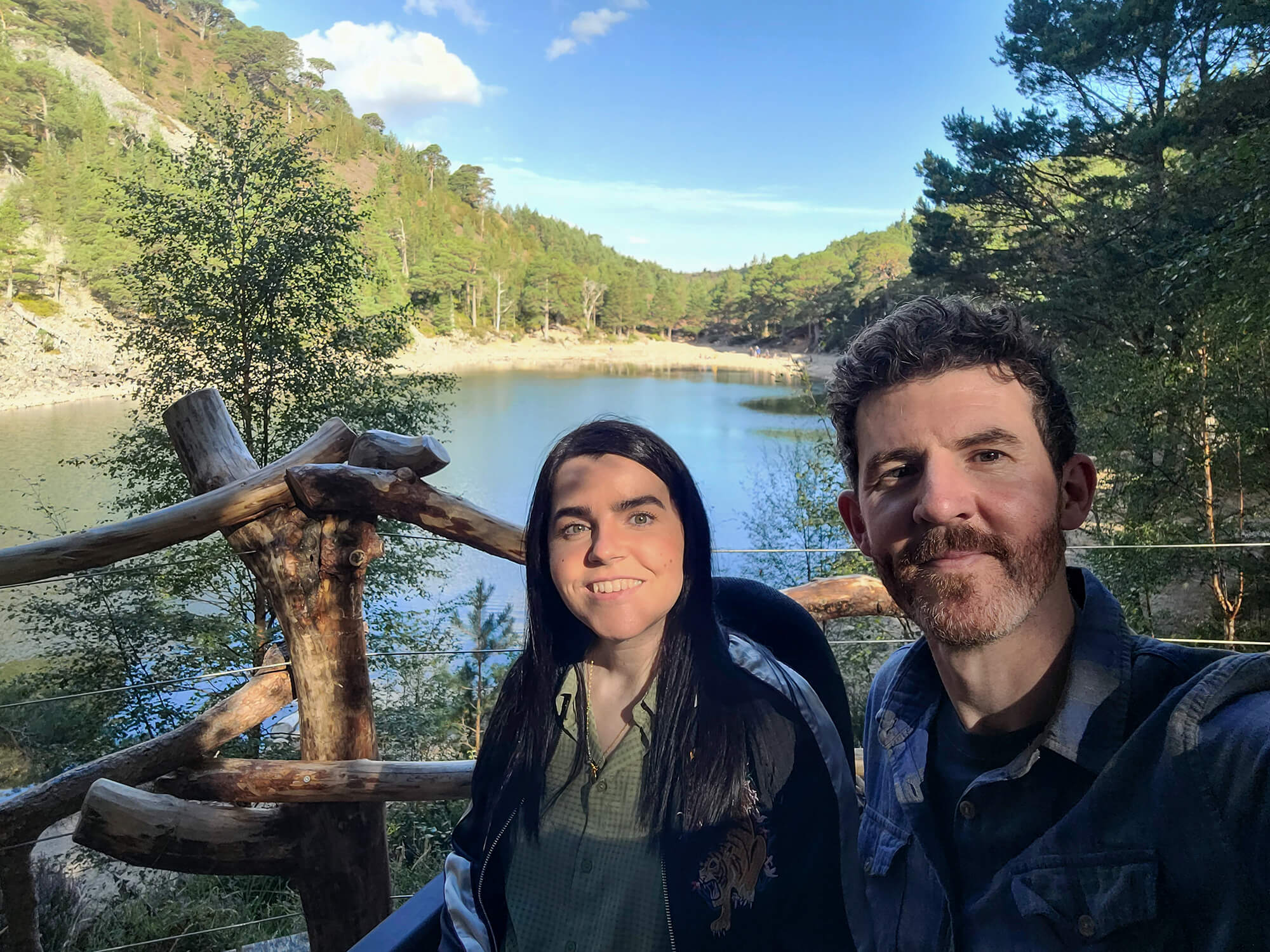 Emma and Allan pictured on the viewing platform with an Lochan Uaine, the Green Loch behind them.
