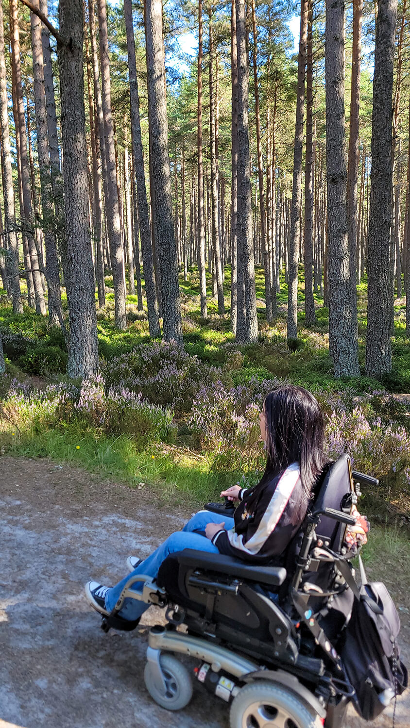 Emma driving her wheelchair along the walking route to An Lochan Uaine.