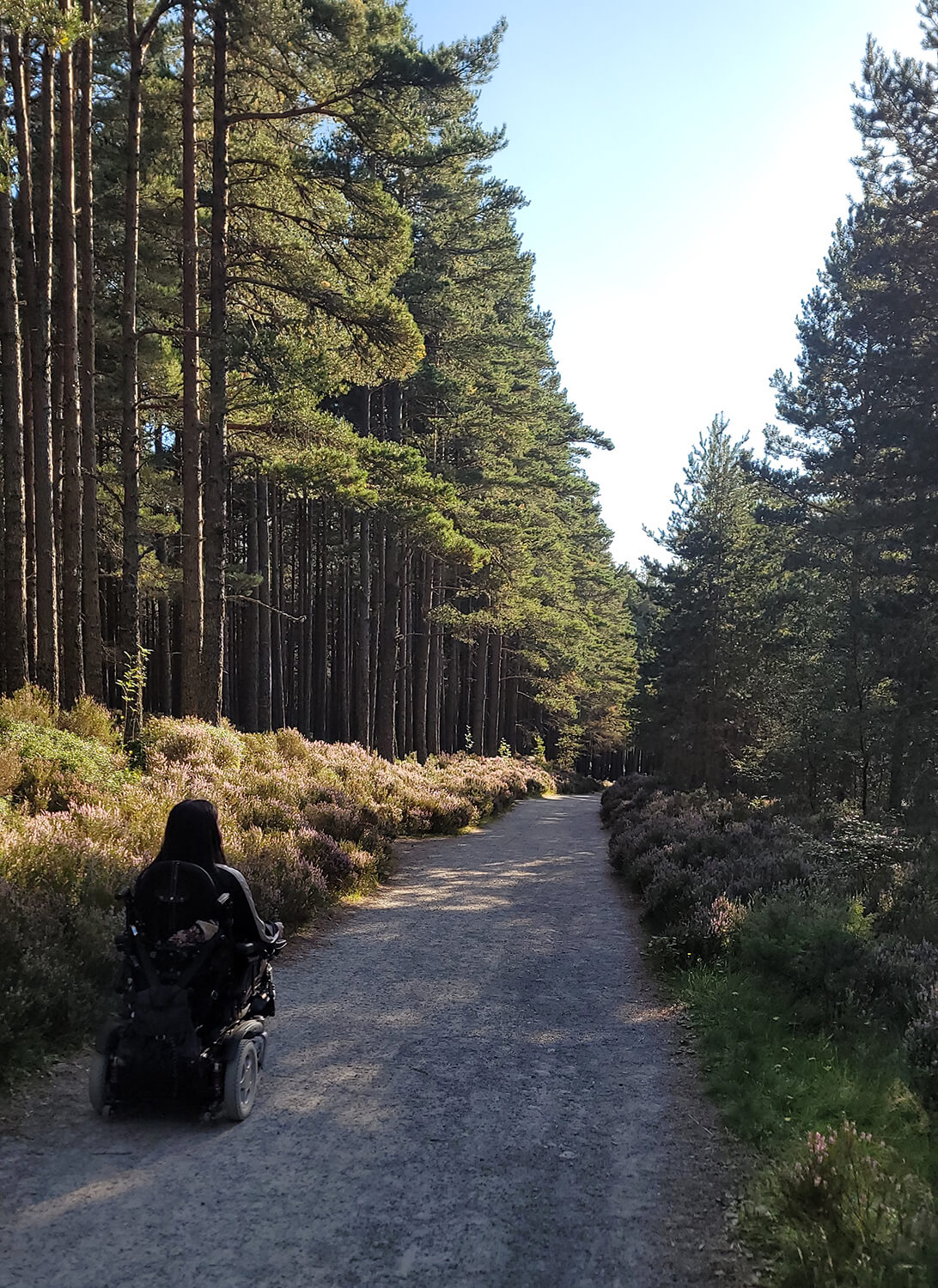 Emma driving her wheelchair along the walking route to An Lochan Uaine.