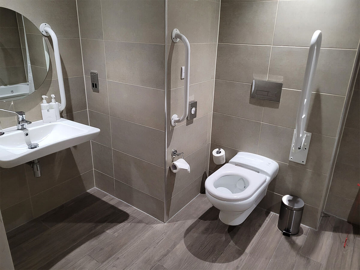 The photo shows the toilet and sink in the wheelchair accessible room at Manchester Marriott Victoria & Albert Hotel.