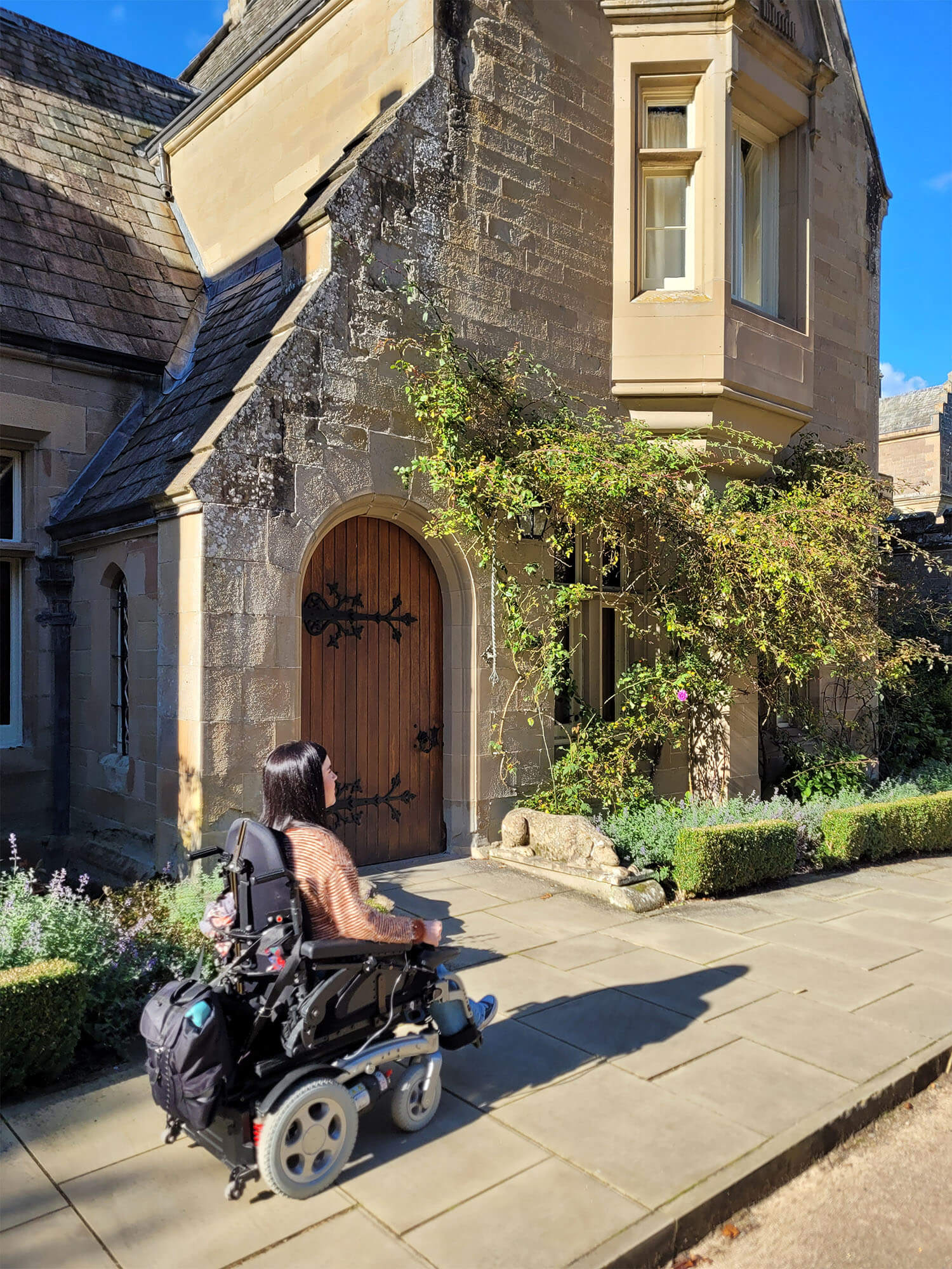 Emma, a powerchair user outside the Chapel at Abbotsford.