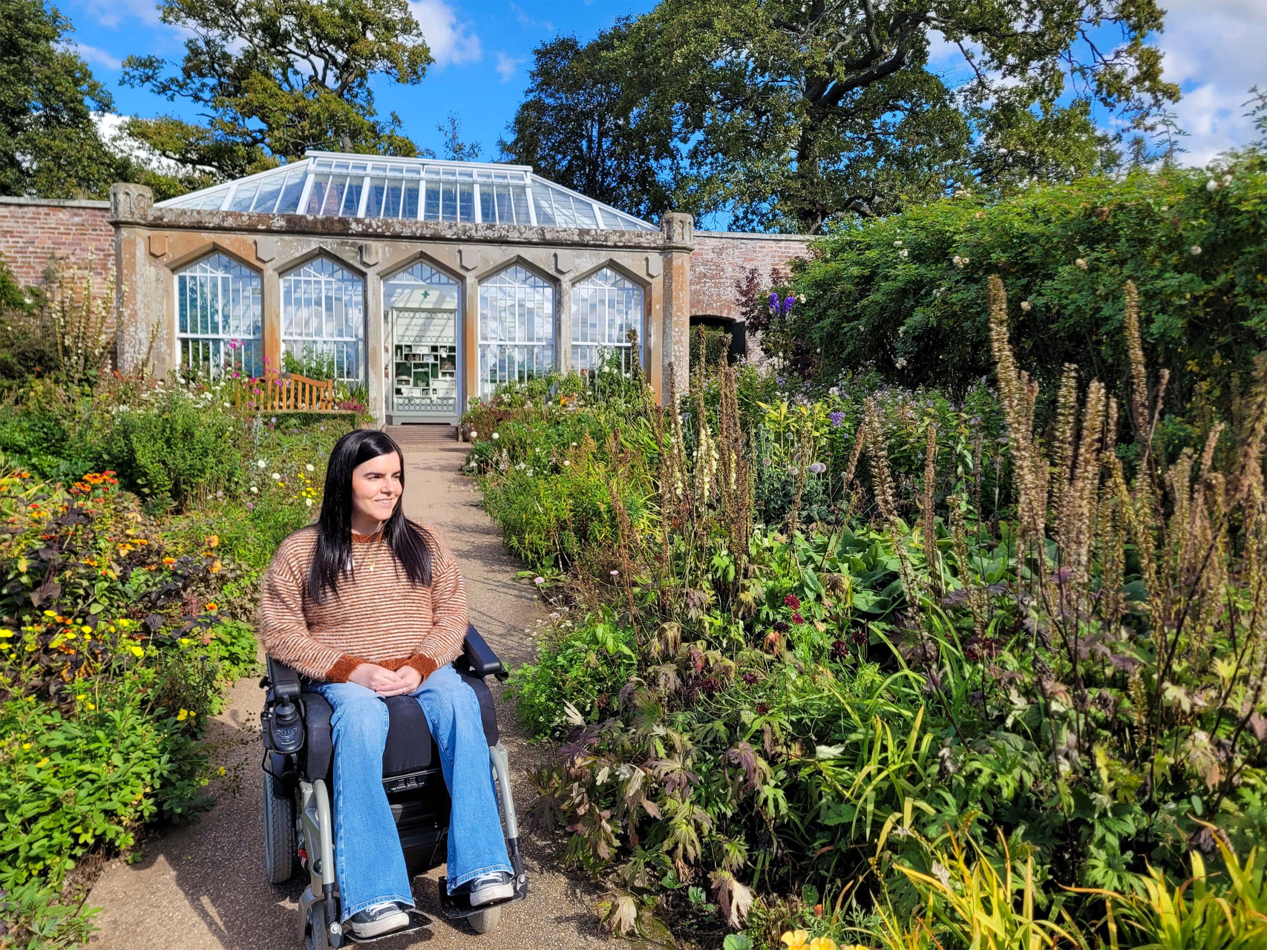 Emma, a power wheelchair user, is pictured in the beautiful garden at Abbotsford House.