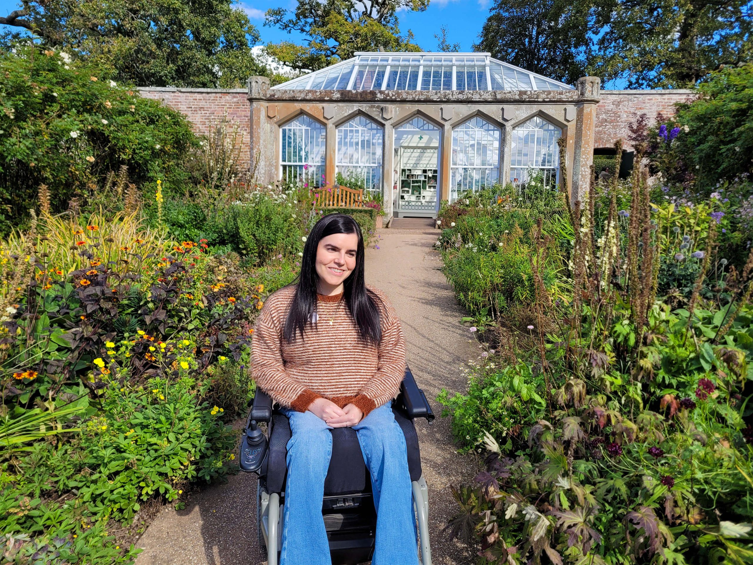 Emma, a power wheelchair user, is pictured in the beautiful garden at Abbotsford House.