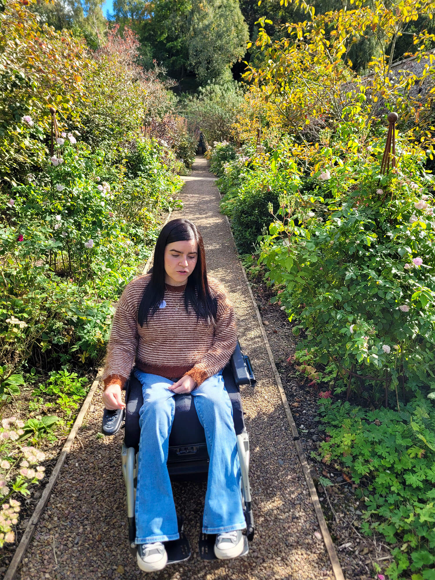 Emma, a power wheelchair user, is pictured in the beautiful garden at Abbotsford House.