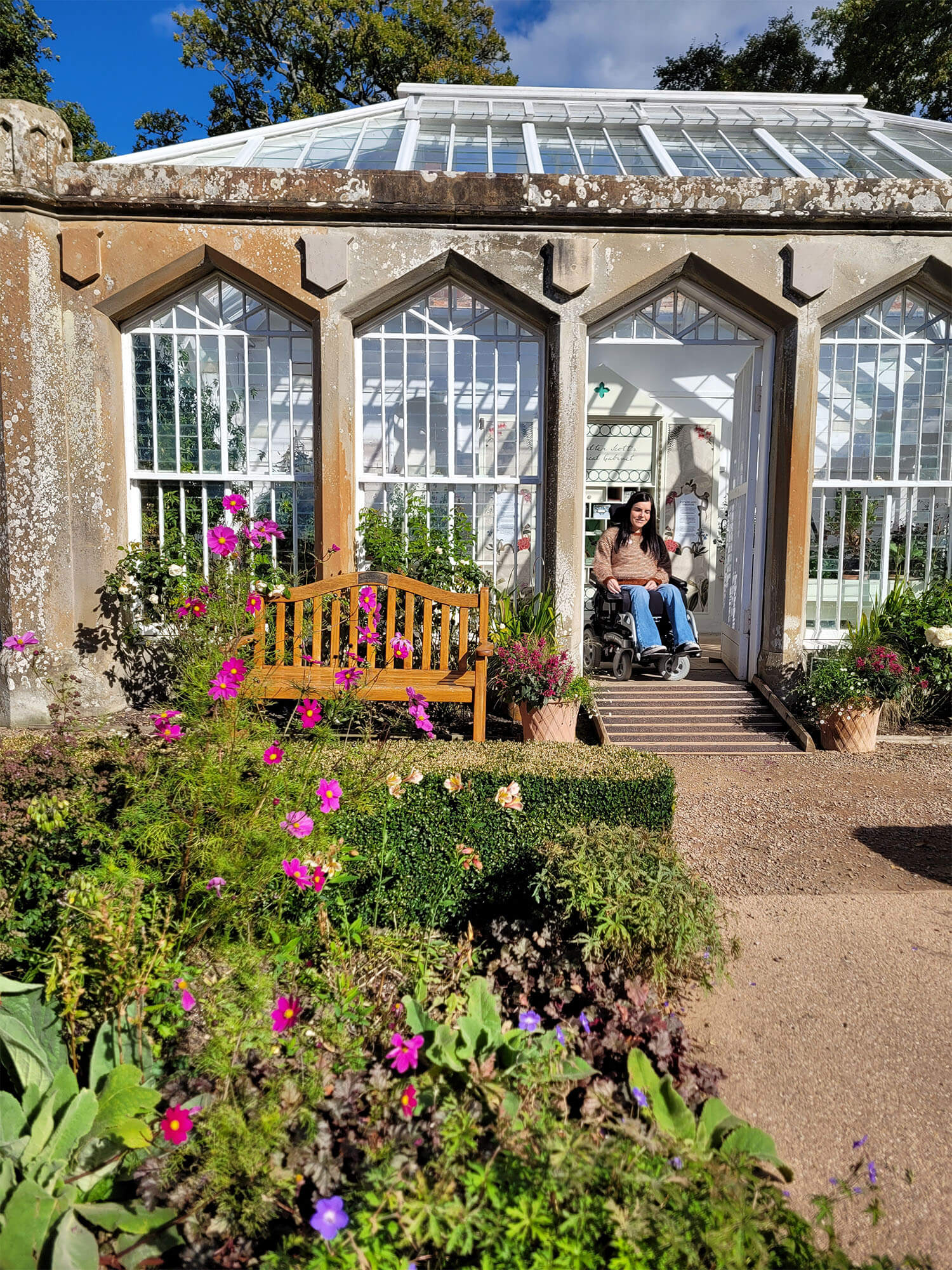 Emma, a power wheelchair user, is pictured in the beautiful garden at Abbotsford House.