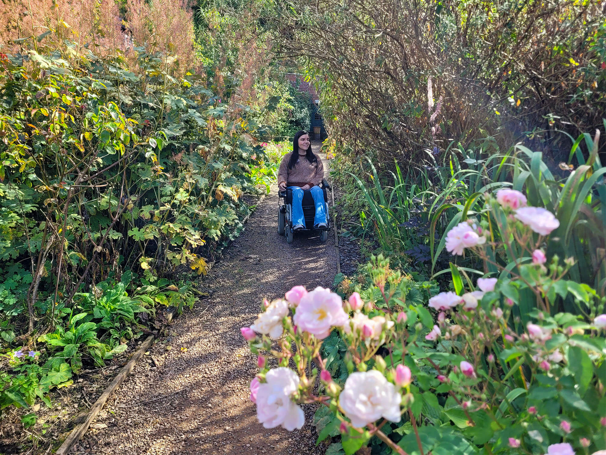 Emma, a power wheelchair user, is pictured in the beautiful garden at Abbotsford House.
