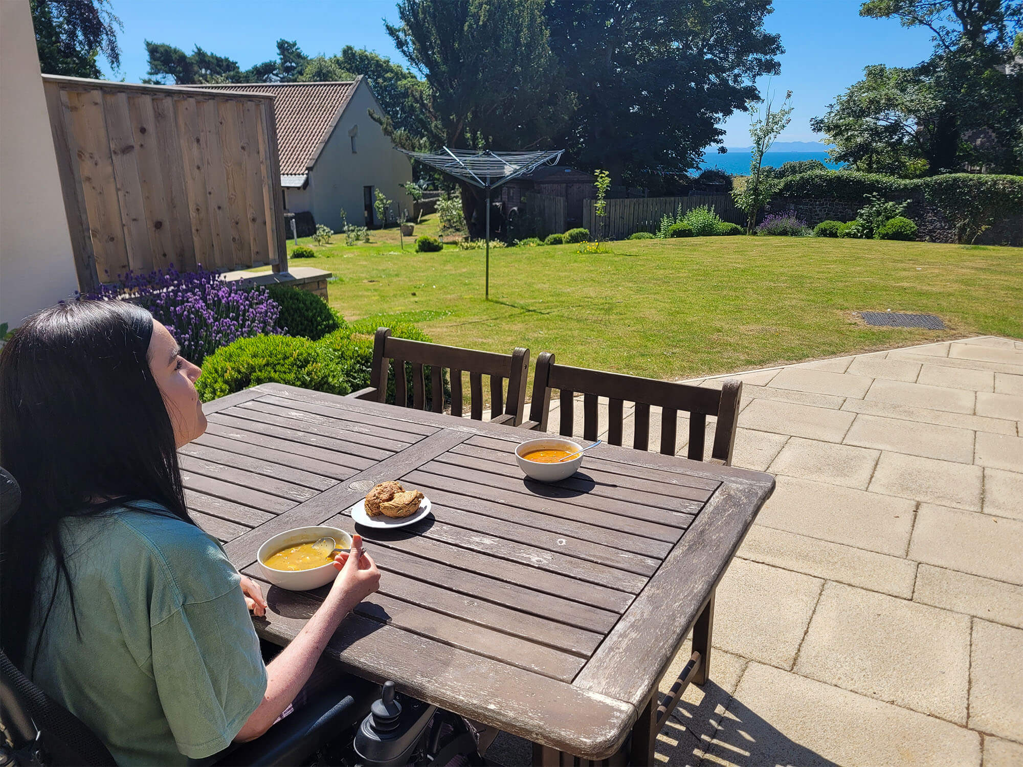 Emma sat outside on the patio enjoying her bowl of soup in the sunshine.