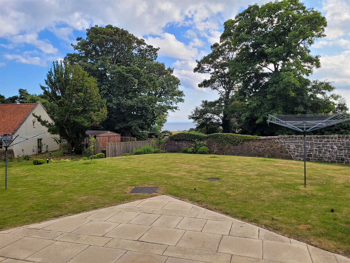 The garden outside the lodge at Homelands Trust-Fife with the Firth of Forth in the distance.
