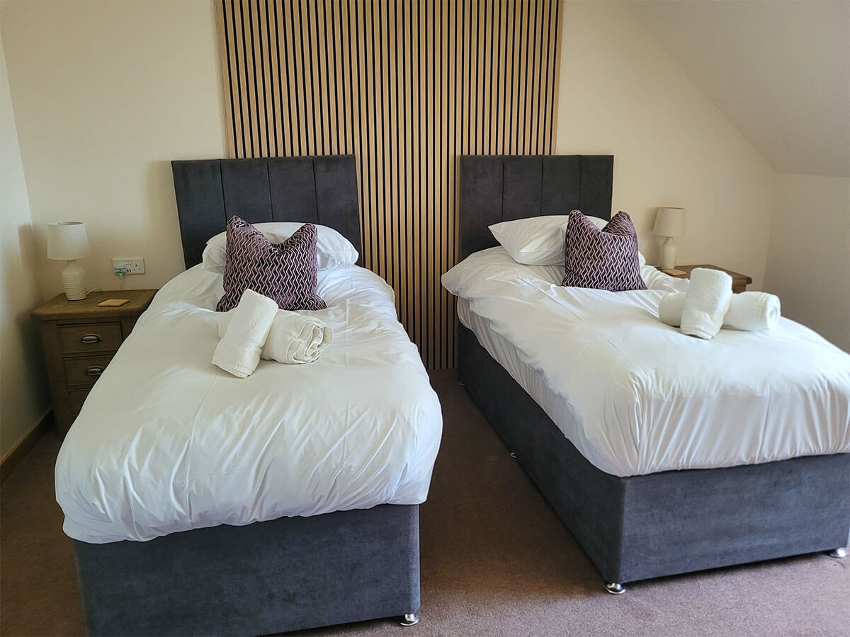 Twin beds in the Largo lodge at Homelands Trust in Fife.