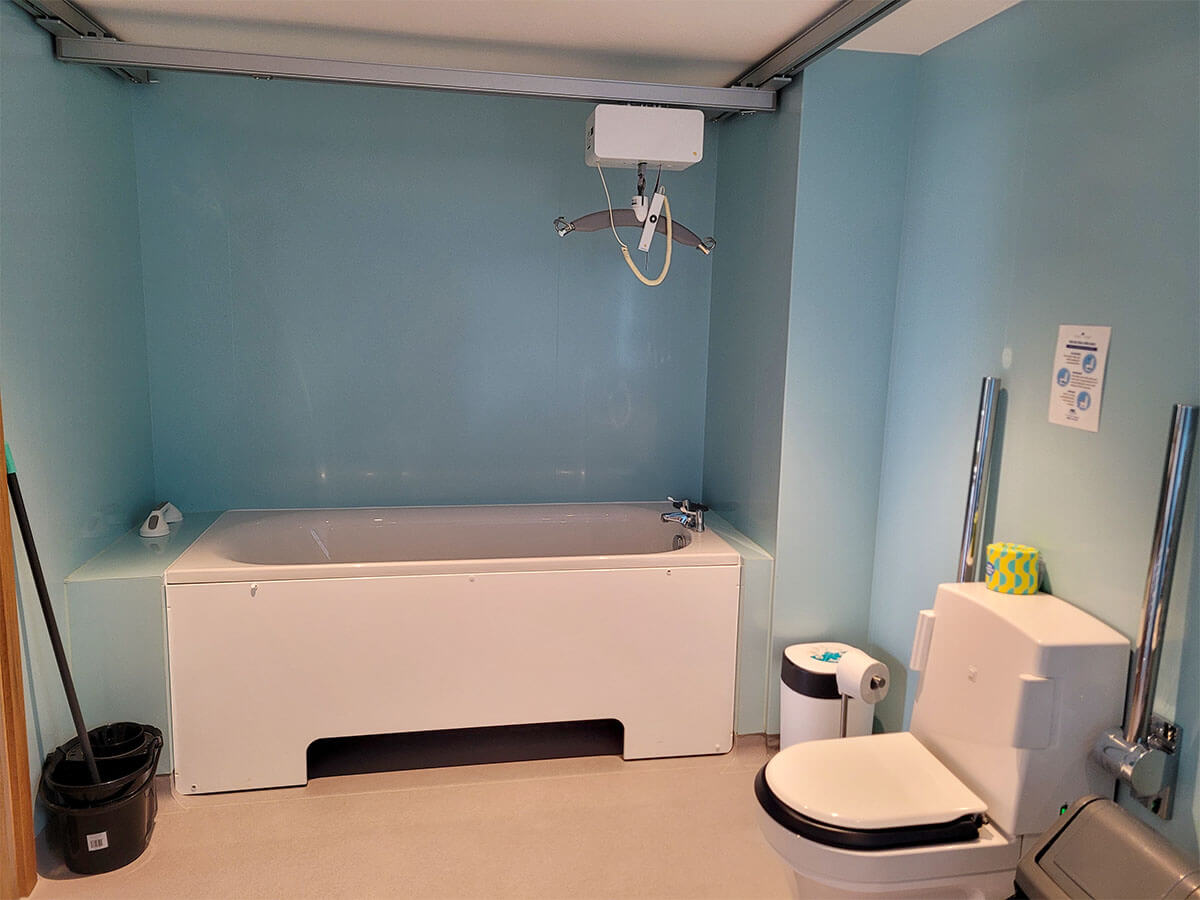 Accessible bath and Closomat wash and dry toilet and ceiling track hoist at Homelands Trust